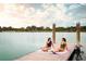 Tranquil view of residents relaxing on a wooden dock next to the lake, a perfect spot for relaxation at 888 S Valentia St # 102, Denver, CO 80247