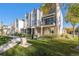 Inviting exterior view of modern townhomes with landscaped front yards and sidewalks at 888 S Valentia St # 102, Denver, CO 80247