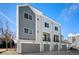 Modern townhome garages with sleek doors and exterior finishes at 888 S Valentia St # 102, Denver, CO 80247