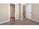 Hallway with light wood floors showing doors to bathroom and stairway to upper floors at 888 S Valentia St # 102, Denver, CO 80247