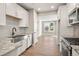 Well-lit kitchen features stainless appliances, granite countertops, and breakfast nook with outdoor view at 888 S Valentia St # 102, Denver, CO 80247