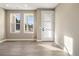 Bright living room featuring wood floors, large windows, and a neutral color scheme at 888 S Valentia St # 102, Denver, CO 80247