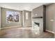 Bright living room features a modern fireplace and views of the neighborhood at 888 S Valentia St # 102, Denver, CO 80247