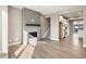 Open-concept living room with modern fireplace and access to the kitchen area at 888 S Valentia St # 102, Denver, CO 80247