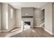 Well-lit living room features a modern fireplace with wood-look floors at 888 S Valentia St # 102, Denver, CO 80247