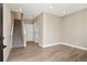 Spacious living room features wood floors, neutral paint, and access to the staircase at 888 S Valentia St # 102, Denver, CO 80247