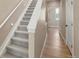 Carpeted stairway with white banister leading to upper floors of the house at 888 S Valentia St # 102, Denver, CO 80247