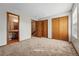 Spacious bedroom featuring carpet, a bathroom, and closets at 12133 Bannock Cir # D, Westminster, CO 80234