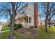 Charming townhouse exterior with well-maintained lawn, mature trees and brick chimney detail at 12133 Bannock Cir # D, Westminster, CO 80234