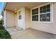 Covered front porch featuring a white door, large window, and manicured landscaping at 12133 Bannock Cir # D, Westminster, CO 80234