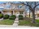 Inviting townhome featuring a well-manicured lawn and covered entryway with small patio at 12133 Bannock Cir # D, Westminster, CO 80234