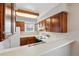 Well-lit kitchen with ample wood cabinetry, white countertops, and a double basin sink at 12133 Bannock Cir # D, Westminster, CO 80234