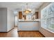Cozy kitchen and dining area featuring wood floors, overhead lighting, and large window at 12133 Bannock Cir # D, Westminster, CO 80234
