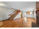 Spacious living room with hardwood floors, brick fireplace, and a staircase to upper level at 12133 Bannock Cir # D, Westminster, CO 80234