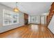Bright living room with hardwood floors, brick fireplace, large windows and natural light at 12133 Bannock Cir # D, Westminster, CO 80234