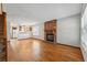 Open-concept living area boasts hardwood floors, brick fireplace and access to kitchen at 12133 Bannock Cir # D, Westminster, CO 80234