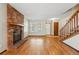 Inviting living area features a brick fireplace, wood floors and a staircase to upper level at 12133 Bannock Cir # D, Westminster, CO 80234