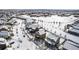 Aerial view of a peaceful residential neighborhood in winter, featuring snow-covered homes and tree-lined streets at 19120 E Pacific Pl, Aurora, CO 80013