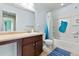 Bright bathroom with a bath tub and a wooden cabinet at 19120 E Pacific Pl, Aurora, CO 80013