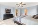 Bedroom with neutral decor, a ceiling fan, and a view into the Primary bathroom at 19120 E Pacific Pl, Aurora, CO 80013