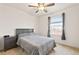 Bright bedroom with a cozy bed, ceiling fan, and an eye-level window at 19120 E Pacific Pl, Aurora, CO 80013