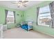 Bright bedroom with a fan, two windows, and a comfortable bed at 19120 E Pacific Pl, Aurora, CO 80013