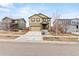 Traditional two-story home boasts a welcoming front exterior with a well-maintained yard and long driveway at 19120 E Pacific Pl, Aurora, CO 80013