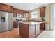 Bright kitchen featuring stainless steel appliances, wood cabinets, granite countertops, and a spacious center island at 19120 E Pacific Pl, Aurora, CO 80013