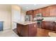 Bright kitchen featuring stainless steel appliances, a center island, wood cabinets, and plenty of counter space at 19120 E Pacific Pl, Aurora, CO 80013