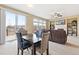 Open living room with a fireplace, a sliding glass door leading to the deck, and a dining table with four chairs at 19120 E Pacific Pl, Aurora, CO 80013