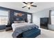 Main bedroom featuring a ceiling fan, large bed, and windows with neighborhood views at 19120 E Pacific Pl, Aurora, CO 80013