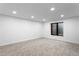 Finished basement room with carpet, egress window, and recessed lighting at 4121 S Cherry St, Cherry Hills Village, CO 80113