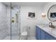 Stylish bathroom with a glass shower, marble details, modern fixtures, and a blue vanity at 4121 S Cherry St, Cherry Hills Village, CO 80113