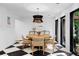 Bright dining room features a round wooden table, woven chairs, and unique black and white flooring at 4121 S Cherry St, Cherry Hills Village, CO 80113