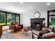 Inviting living room with a fireplace, modern seating, and a large window overlooking the yard at 4121 S Cherry St, Cherry Hills Village, CO 80113