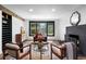 Cozy living room with fireplace, stylish seating, and large windows offering natural light at 4121 S Cherry St, Cherry Hills Village, CO 80113