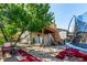 Backyard featuring a deck with stairs, trampoline, and a shady tree at 3296 S Bryant St, Englewood, CO 80110