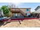 Exterior shot of a backyard deck with stairs and a trampoline at 3296 S Bryant St, Englewood, CO 80110