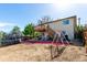 Home exterior with deck, stairs, swing set, and trampoline in the backyard at 3296 S Bryant St, Englewood, CO 80110