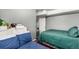 Cozy bedroom featuring two beds, a closet, and neutral-toned walls at 3296 S Bryant St, Englewood, CO 80110
