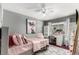 Bright bedroom featuring a ceiling fan, a desk and chair, and a well-decorated style at 3296 S Bryant St, Englewood, CO 80110