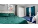 Comfortable bedroom featuring two beds, a closet, and a window with blue curtains at 3296 S Bryant St, Englewood, CO 80110