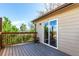 Exterior view of wooden deck featuring wooden railings and sliding glass door access at 3296 S Bryant St, Englewood, CO 80110