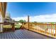 Spacious wooden deck features wooden railings with green space and city views at 3296 S Bryant St, Englewood, CO 80110