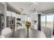 A cozy dining area next to the kitchen features stainless steel appliances and access to the outside deck at 3296 S Bryant St, Englewood, CO 80110