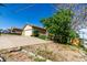 Wide driveway leading to a two-car garage, surrounded by mature trees and landscaping at 3296 S Bryant St, Englewood, CO 80110