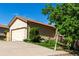 Home featuring a two-car garage, neutral siding and mature landscaping at 3296 S Bryant St, Englewood, CO 80110