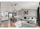 Open floor plan featuring a living room, dining area, and kitchen with modern decor at 3296 S Bryant St, Englewood, CO 80110