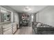 Living area with neutral tones, showcasing furniture, shelving, rug, tile floors and ample storage at 3296 S Bryant St, Englewood, CO 80110