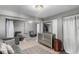Neutral toned living area showcases comfortable seating, tile flooring, and natural light at 3296 S Bryant St, Englewood, CO 80110